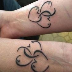 two people with matching tattoos on their arms