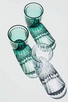 three glass vases sitting on top of each other