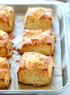 nine pieces of bread sitting on top of a baking pan next to a purple flower