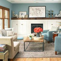 a living room filled with furniture and a fire place under a painting on the wall