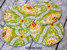 four coasters made out of green and yellow fabric