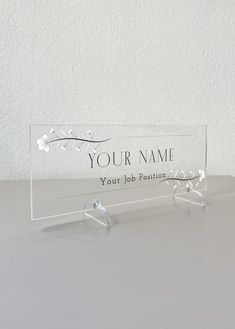 a clear acrylic business card holder sitting on top of a white countertop