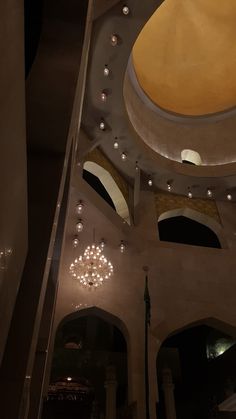 the inside of a building with chandeliers hanging from the ceiling