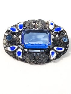 Lovely brooch with deep blue colors. Designed with blue enamel guilloche leaves and small glass accents. Small amount of wear in pin backing. On the first picture top right there is a small amount of wear to the blue of the enamel but the white is still intact. Great working clasp. Good vintage condition with very little wear. Center stone is open work and prong set where the chaton accents on the sides are bevel set into the piece. This line was designed by Neiger Brothers and showcases the uni Sparkly Costume, Bohemian Art, Sterling Silver Brooch, Enamel Brooch, Silver Art, Silver Brooch, Silver Blue, Vintage Brooches, Estate Jewelry