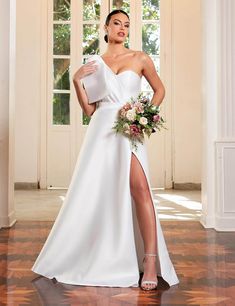 a woman in a white wedding dress posing with her leg on the floor and wearing high heels