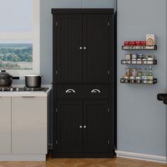 a black cabinet in the corner of a kitchen