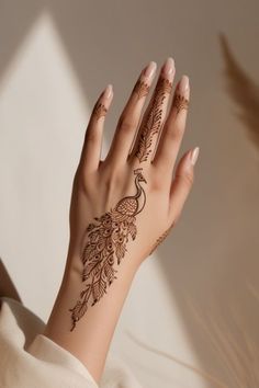 a woman's hand with henna tattoos on it