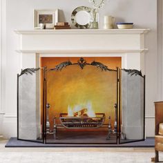 a fireplace with a fire in it next to a chair