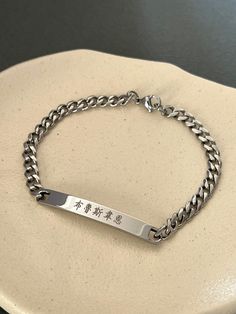 This listing is for a personalized engraved Chinese name large bar bracelet in stainless steel. Stainless steel jewelry is strong and almost never tarnish or corrode. The sample bracelet is engraved with the name Bruce Wayne in Chinese in the font #4 on the front and the date is engraved in the font #13 on the back of the bar. Please check the font options in the pictures: the font #3,4 & 5 is only written in traditional Chinese and #6 is only written in simplified Chinese. #1 and 2 is available Silver Stainless Steel Name Bracelet With Engraved Text, Custom Name Stainless Steel Bracelet, Engraved Rectangular Stainless Steel Bracelets, Rectangular Engraved Stainless Steel Bracelets, Rectangular Stainless Steel Engraved Bracelets, Chinese Men, Large Bar, Medical Bracelet, Chinese Name