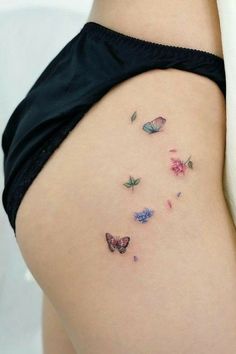 a woman's thigh with butterflies on it and the words clever tattoos that aren't what they seem at first glance