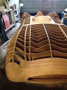 a wooden car being built in a garage