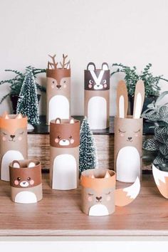 some paper cups with animals and trees on them