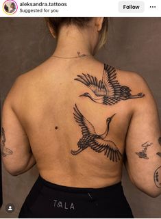 the back of a woman's body with tattoos on her upper and lower back