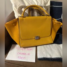 These Are Professional Photos Of The Item Itself! Beautiful Yellow Cline Trapeze Bag Medium In Leather And Suede. From 2014 And Has A Detachable Strap. There Is Some Relaxing To Shape. Typical Markings And Scuffing To Leather And Scratches And Spotting To Hardware With Usual Wear. Some Staining On The Interior (Shown In Photos). Does Not Include The Original Box, Bag Or Receipts. Dimensions Are 11.75" W 9.0" H 6.75" D Poshmark Will Authentic Guarantee All Purchases Over $500! Chic Yellow Flap Bag For Everyday Use, Chic Yellow Satchel Flap Bag, Chic Yellow Satchel With Dust Bag, Chic Yellow Flap Bag For Travel, Designer Yellow Satchel For Everyday Use, Designer Yellow Satchel For Everyday, Shopping Bags With Gold-tone Hardware And Flap, Yellow Flap Bag With Gold-tone Hardware For Everyday, Chic Flap Bags For Shopping