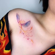 a woman with a colorful tattoo on her chest