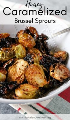 a white bowl filled with brussel sprouts on top of a table