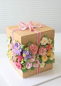 a cake decorated with flowers and ribbons