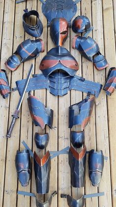 an assortment of different types of armor on a wooden floor