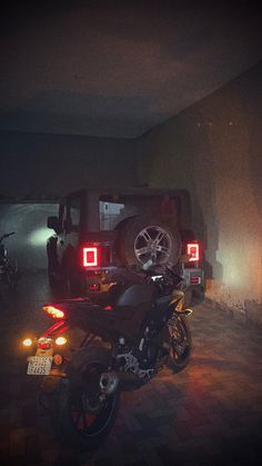 two motorcycles parked next to each other in a garage