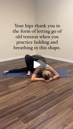 a woman is doing yoga on the floor in front of a wall with an inspirational quote