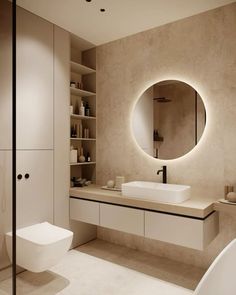 a bathroom with a round mirror above the sink and toilet in front of a bathtub