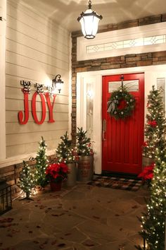 a red front door decorated with christmas decorations