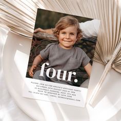 a white plate topped with a photo of a young boy and the words four on it