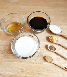 the ingredients to make this dish are in bowls and wooden spoons on the table