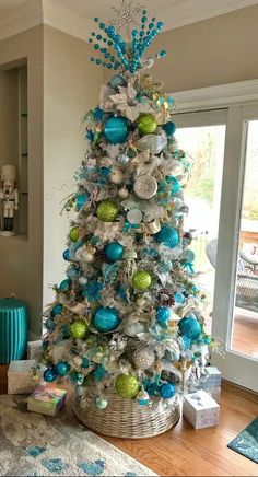 a blue and silver christmas tree in a living room