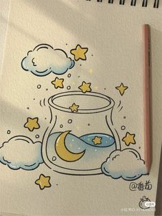 a drawing of a glass jar with stars and moon in it on top of a notebook