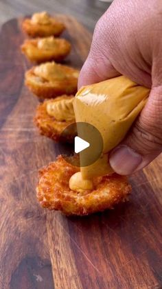 a person is dipping sauce on some fried food in order to make it look like they are eating something