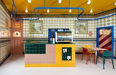 the interior of a restaurant with brightly colored tiles on the walls and ceiling, along with colorful tables and chairs