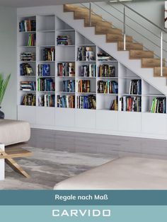 a living room filled with furniture and bookshelves next to a stair case full of books