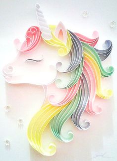 a paper cut out of a rainbow colored unicorn