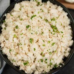 a black bowl filled with rice on top of a table