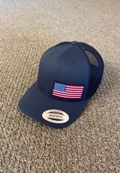 "This is a NEW United States of America Flag Embroidered Patch applied by hand to a high quality Yupoong or Richardson brand SnapBack Hat Yupoong Classic SnapBacks are 65% Polyester/35% Cotton, Structured, mid-profile, 3 1/2\" crown, six-panel Permacurv Visor adjustable plastic snapback closure 6 7/8\" to 7 1/2\" Richardson Hats are 60% cotton/40% polyester Structured, mid-profile, six-panel Pre-curved Visor adjustable plastic snapback closure 6 3/4\" -7 5/8\" Every Hat Design we offer is Create United States Of America Flag, Richardson Hats, American Flag Hat, Flag Hat, America Flag, Hats Snapback, Mesh Cap, White Mesh, Us Flag