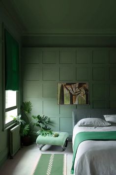 a bedroom with green walls and white bedding in front of a window that reads, farrow & ball surround yourself in tasting color with new, multi - surface dead flat