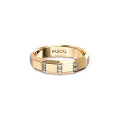 a gold ring with three diamonds on the side and an inscription that reads pascal