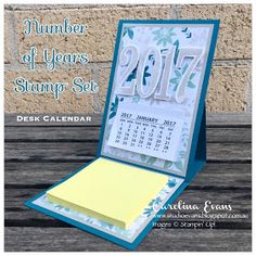 a desk calendar sitting on top of a wooden table next to a wall with the words, number of years stamp set