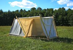 a tent is set up in the middle of a field