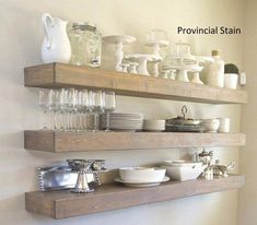 two wooden shelves filled with dishes and glasses