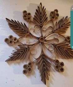 a snowflake made out of cardboard with scissors