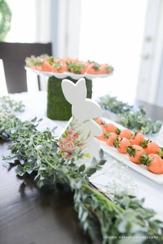 carrots and other vegetables are arranged on the table for an easter bunny party treat