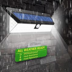 an all weather ready sign in front of a brick wall with a solar panel on it