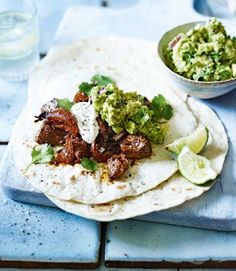 two tortillas with meat and guacamole on top