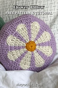 a crocheted flower pillow sitting on top of a white bed with text overlay that reads, flower pillow free pattern and video