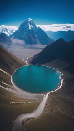 an aerial view of a lake surrounded by mountains