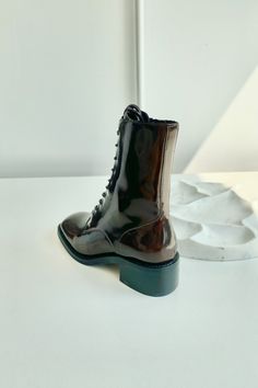 Guide Boot Brown patent leather boots. Lace-up front Side zip closure Round toe Heel Height: 2" Leather Upper | Synthetic Sole Patent Leather Boots, Round Toe Heels, Jeffrey Campbell, Brown Boots, Lace Up Boots, Leather And Lace, Side Zip, Leather Boots, Patent Leather