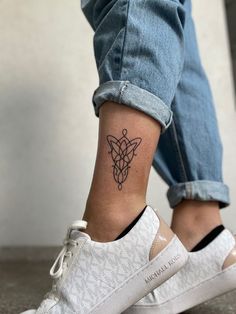 a person with a small tattoo on their ankle