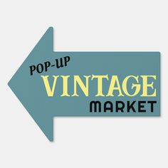 a sign that says pop up vintage market with an arrow pointing in the opposite direction